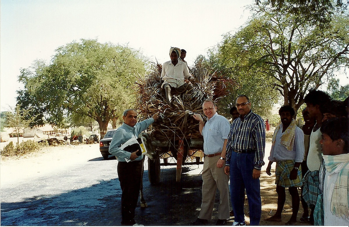 CK Prahalad (right), stands before a bullock cart during an executive program in India run by the University of Michigan in the mid-1990s. (Photograph: Courtesy Prahalad Family)