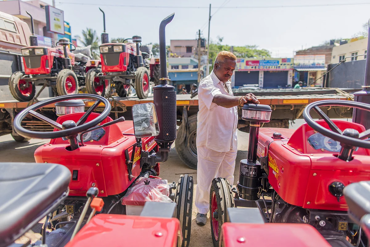 A customer looks at a Mahindra Yuvraj 215 NXT tractor, at a dealership in Tumakuru, Karnataka, on March 8, 2018. (Photographer: Prashanth Vishwanathan/Bloomberg)