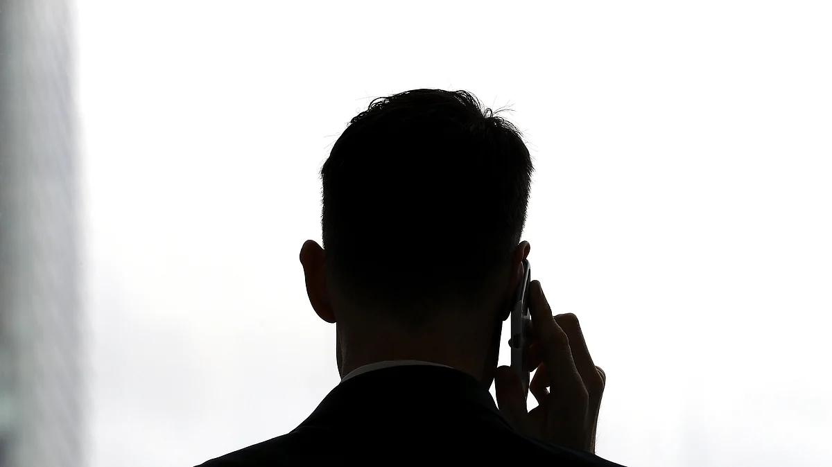 The silhouette of a man talking on a mobile phone. (Photographer: Aaron M. Sprecher/Bloomberg)