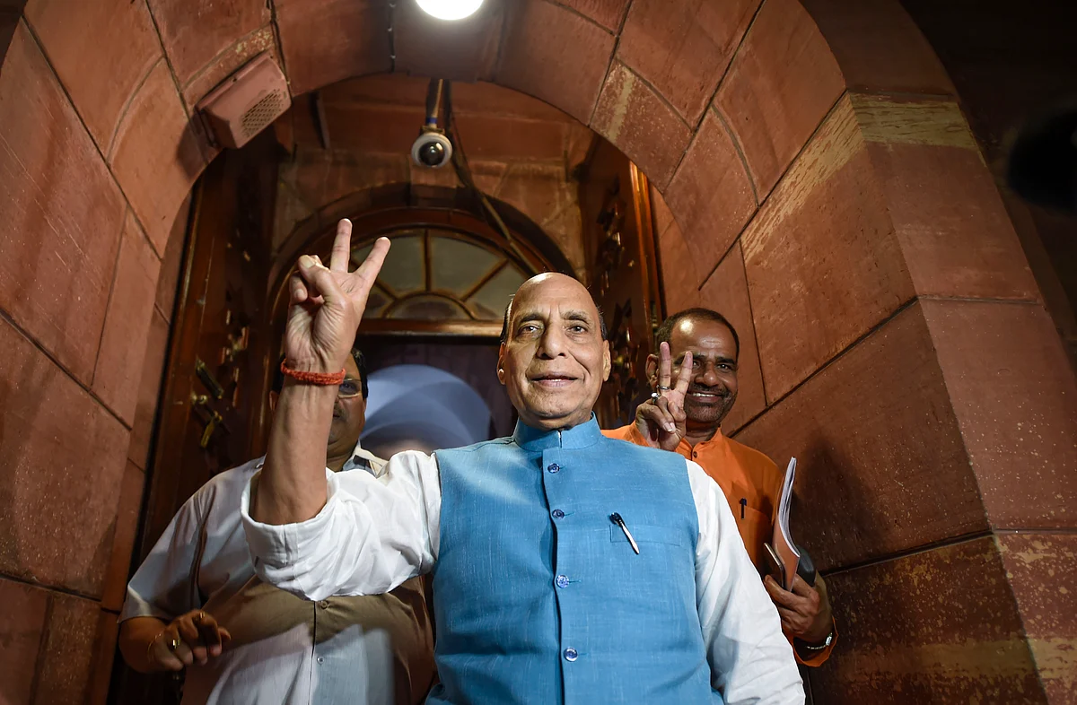 Defence minister Rajnath Singh flashes a victory sign after the Lok Sabha was adjourned. (Source: PTI)