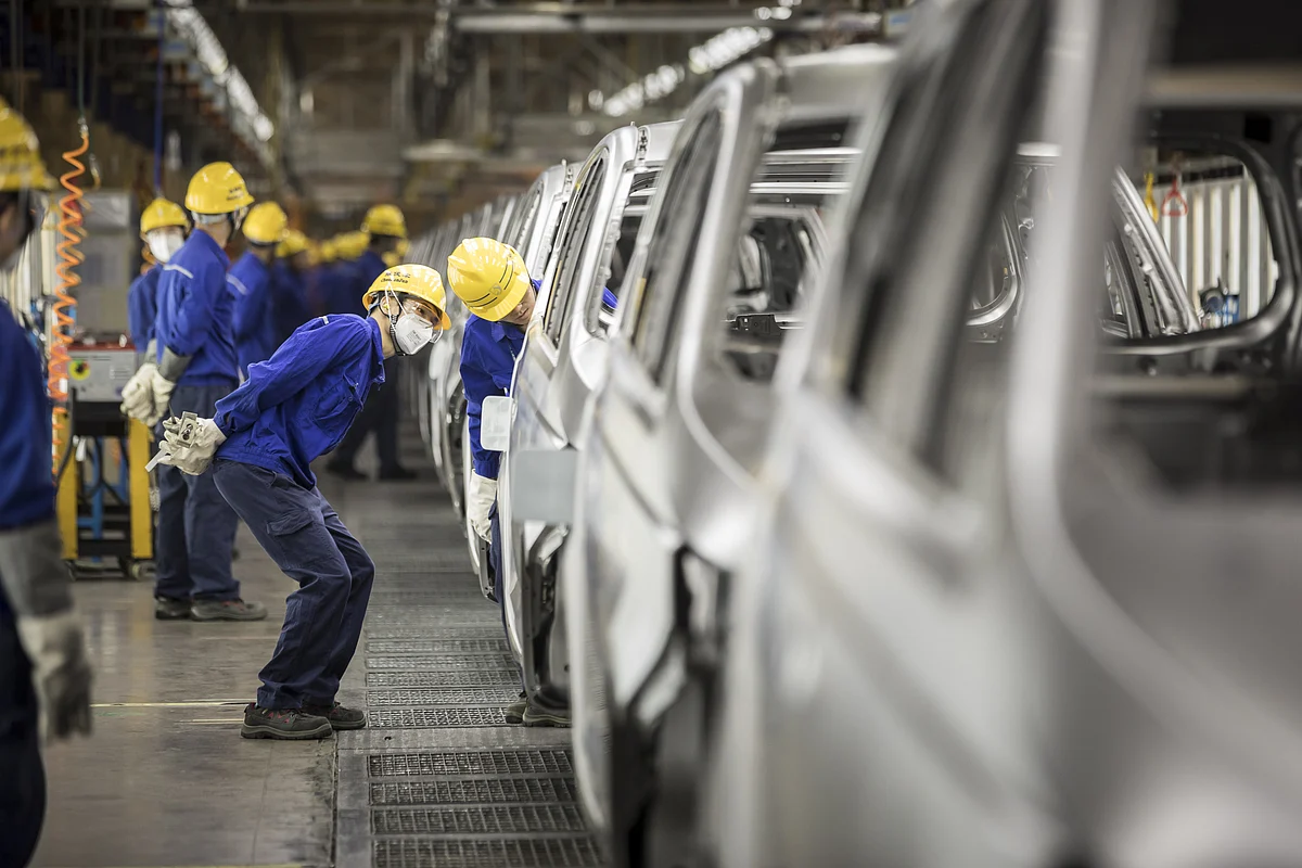 Workers inspect vehicles in the weld shop at the SAIC-GM-Wuling Automobile plant, in Liuzhou, Guangxi province, China. (Photographer: Qilai Shen/Bloomberg)
