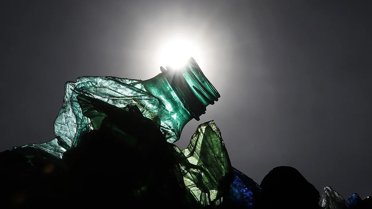 A crushed plastic bottle sits waiting to be recycled. (Photographer: Stefan Wermuth/Bloomberg)