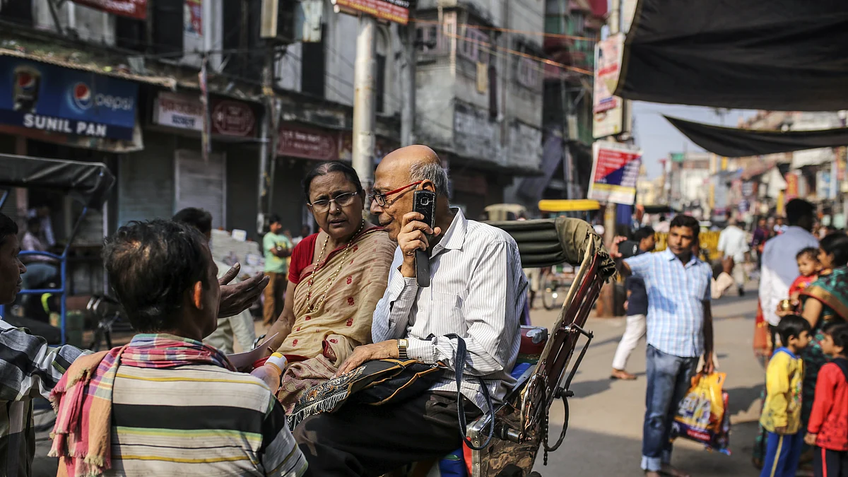 A man speaks on a mobile phone while seated in a rickshaw in Varanasi, Uttar Pradesh. Photographer: Dhiraj Singh/Bloomberg