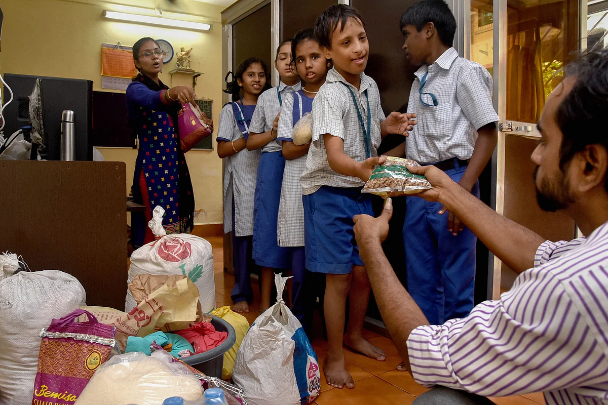 Specially-abled children donate food packets for the flood-affected, in Navi Mumbai, on Aug. 13, 2019. (Photograph: PTI)