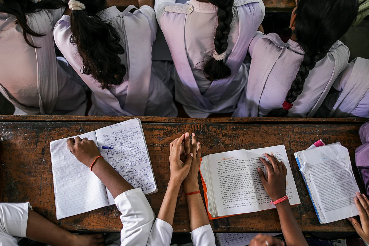 Students sit studying at a college in, Uttar Pradesh. (Photographer: Dhiraj Singh/Bloomberg)