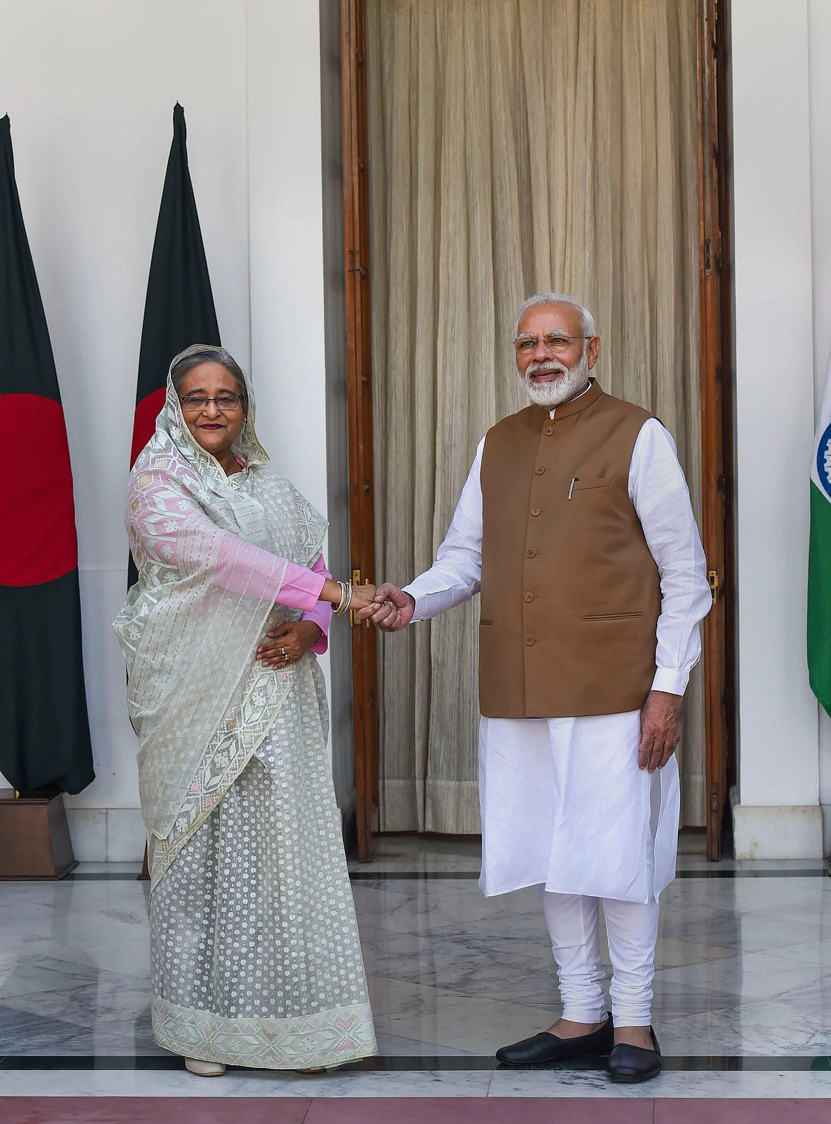 Prime Minister Narendra Modi shakes hands with his Bangladeshi counterpart Sheikh Hasina prior to a meeting at Hyderabad House in New Delhi, on Oct. 5, 2019. (Photographer: Atul Yadav/PTI)