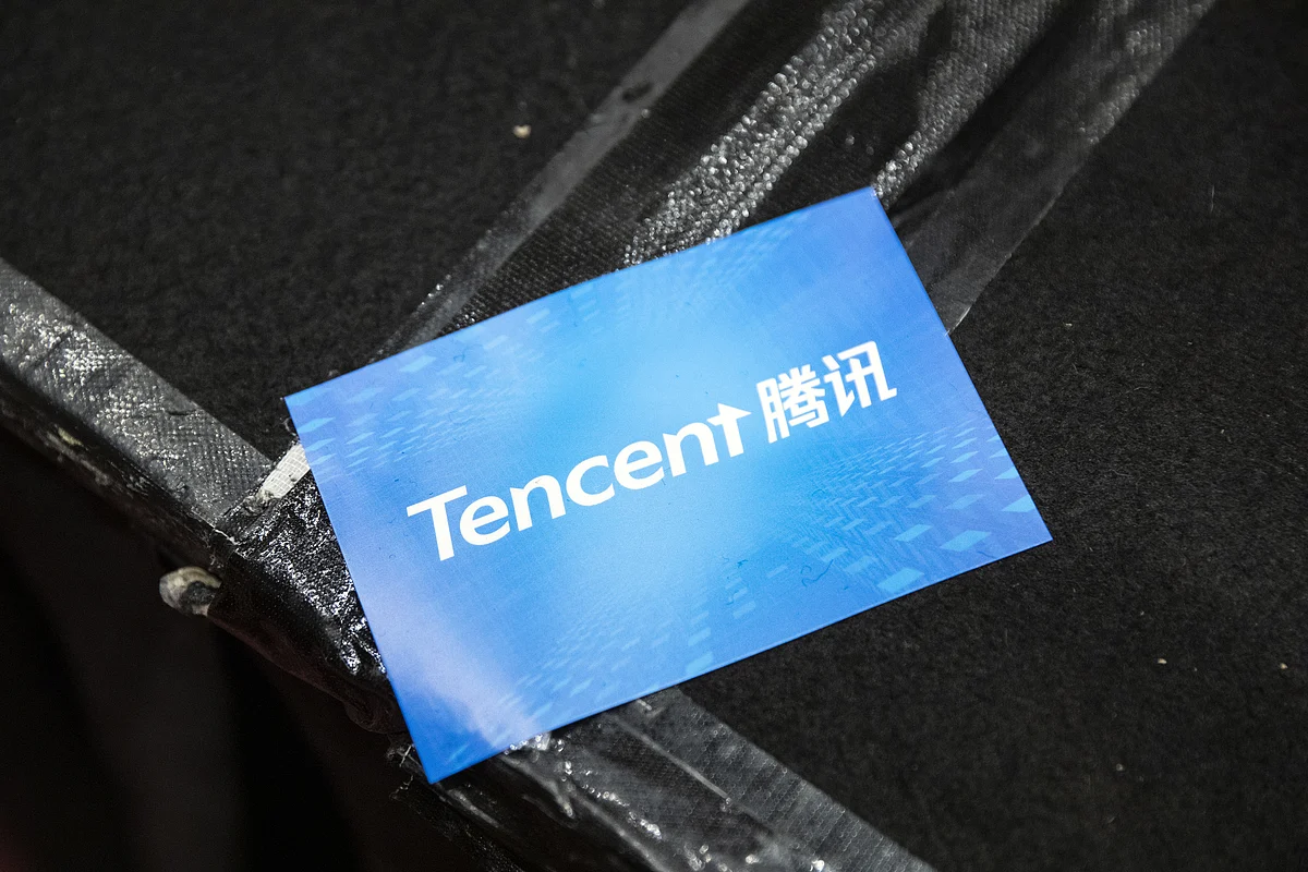 A sticker featuring the logo of Tencent Holdings Ltd. is seen during a news conference in Hong Kong, China. (Photographer: Justin Chin/Bloomberg)