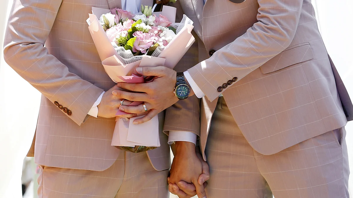 A married couple holds a bouquet during a pro same-sex marriage party organized by the Taipei City government and Marriage Equality Coalition Taiwan in Taipei, Taiwan. (Photographer: Ashley Pon/Bloomberg)