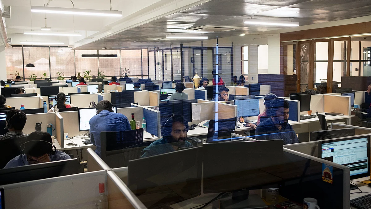 Employees work at a software services firm in Bengaluru, India. (Photographer: Karen Dias/Bloomberg) 