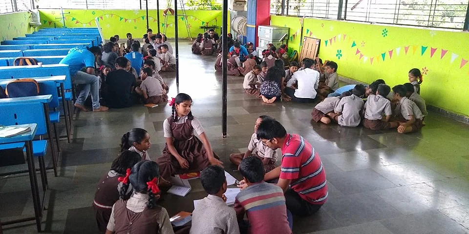 Outreach volunteers with school children in Mumbai. (Photograph: Cognizant)