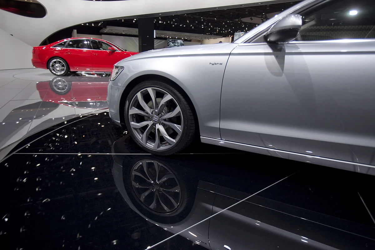The 2012 Audi AG A6 sedan, left, and Audi A6 Hybrid sit on display at the North American International Auto Show (NAIAS) in Detroit. (Photographer: Andrew Harrer/Bloomberg)