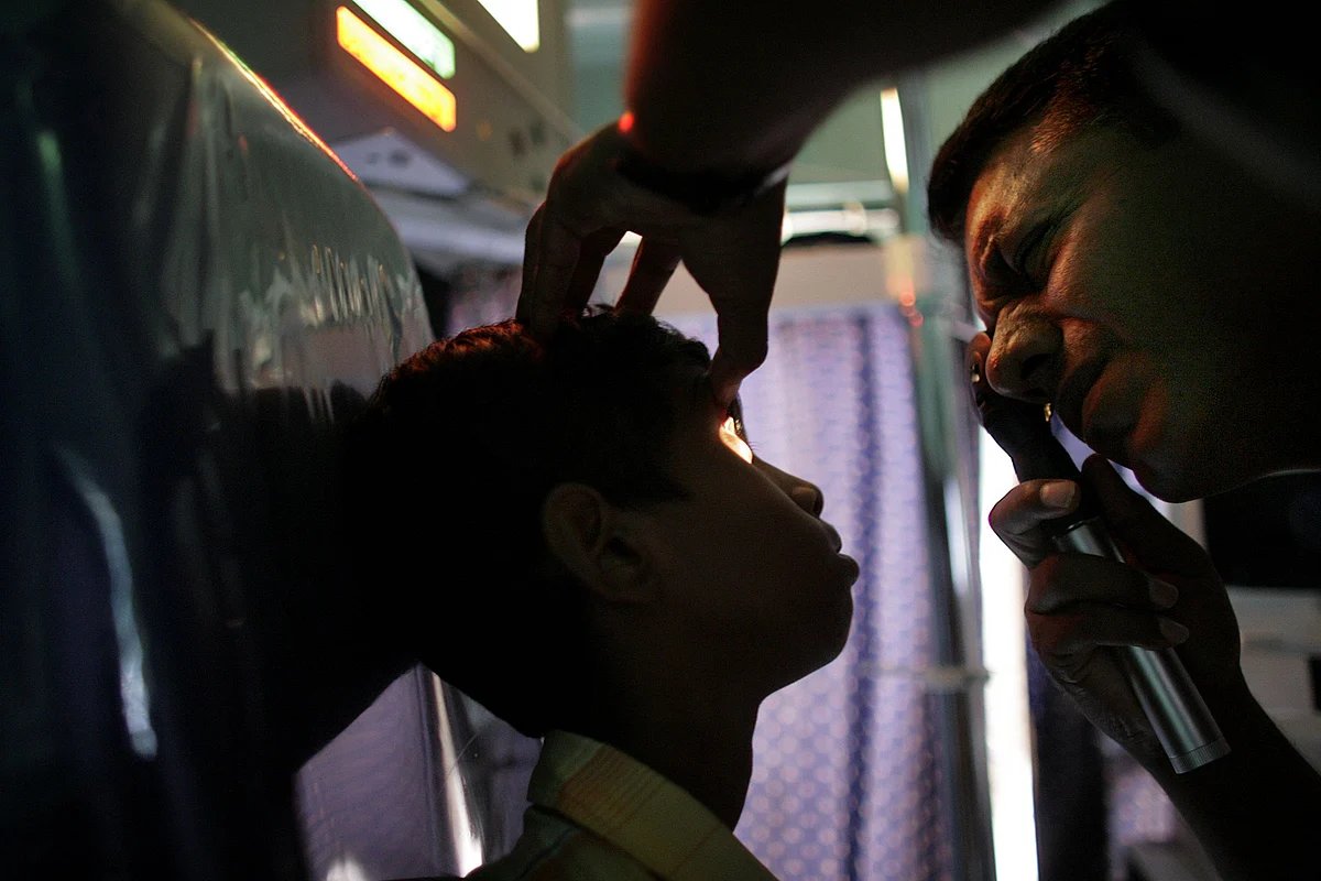 A doctor examines the eyes of a child in Palghar, India. (Photographer: Scott Eells/Bloomberg News)