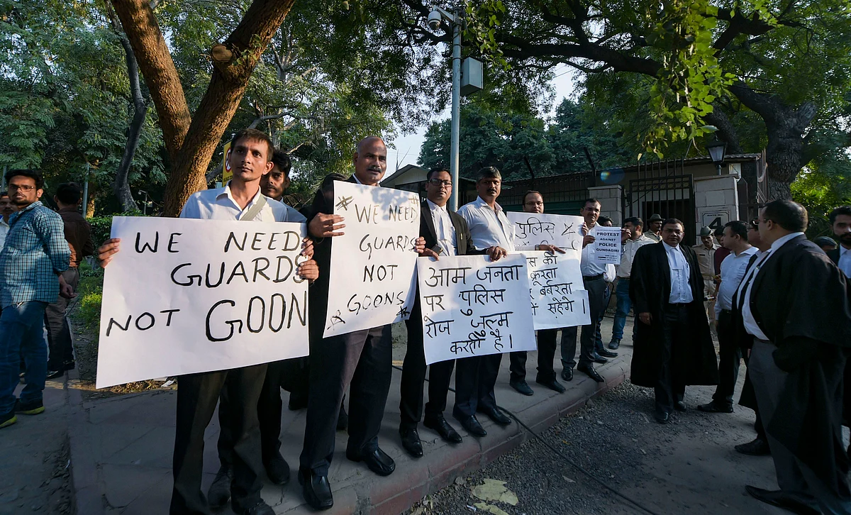 Lawyers display placards during their protest against the police outside the Delhi High Court. (Source: PTI)