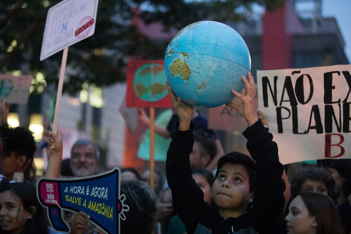 A child holds a globe during the Global Climate Strike demonstration in Sao Paulo, Brazil. (Photographer: Patricia Monteiro/Bloomberg) 