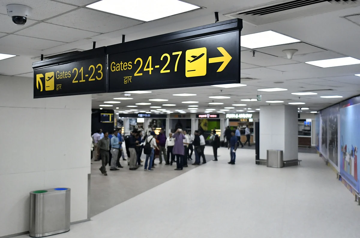 Signs pointing to departure gates hang inside newly inaugurated Terminal 2 building at the Indira Gandhi International Airport in Delhi, India. (Photographer: Anindito Mukherjee/Bloomberg) 