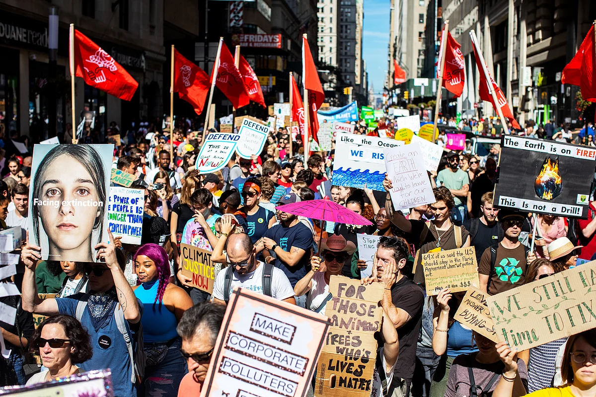 Protesters hold signs during the Global Climate Strike demonstration in New York. (Photographer: Demetrius Freeman/Bloomberg) 
