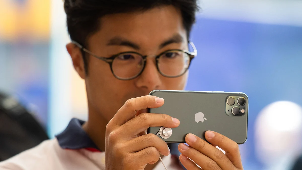 A customer uses an Apple Inc. iPhone 11 Pro smartphone at an Apple store during a product launch event in Hong Kong, China. (Photographer: Kyle Lam/Bloomberg)