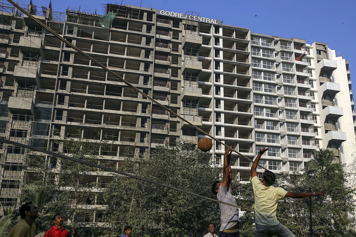 Men play volleyball near the under construction Godrej Prime, a residential propert project developed by Godrej Properties Ltd. (Photographer: Dhiraj Singh/Bloomberg)