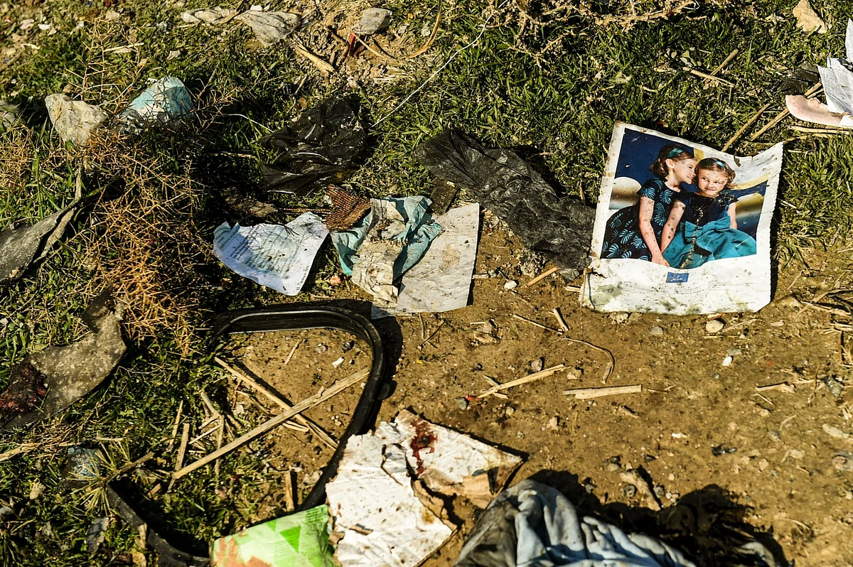 A page from a magazine lies amongst the wreckage from a Boeing Co. 737-800 aircraft, operated by Ukraine International Airlines, which crashed shortly after takeoff near Shahedshahr, Iran. (Photographer: Ali Mohammadi/Bloomberg)