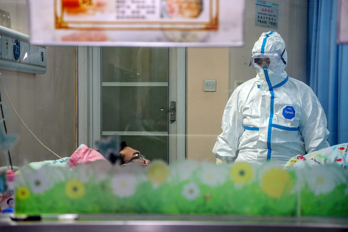 A doctor attends to a patient in an isolation ward at a hospital in Wuhan in central China’s Hubei Province, Thursday, Jan. 30, 2020. (Source: PTI)