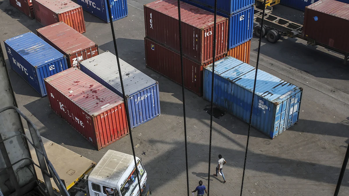 A truck sits parked next to shipping containers at the Jawaharlal Nehru Port, operated by Jawaharlal Nehru Port Trust (JNPT), in Navi Mumbai, Maharashtra, India. (Photographer: Dhiraj Singh/Bloomberg)