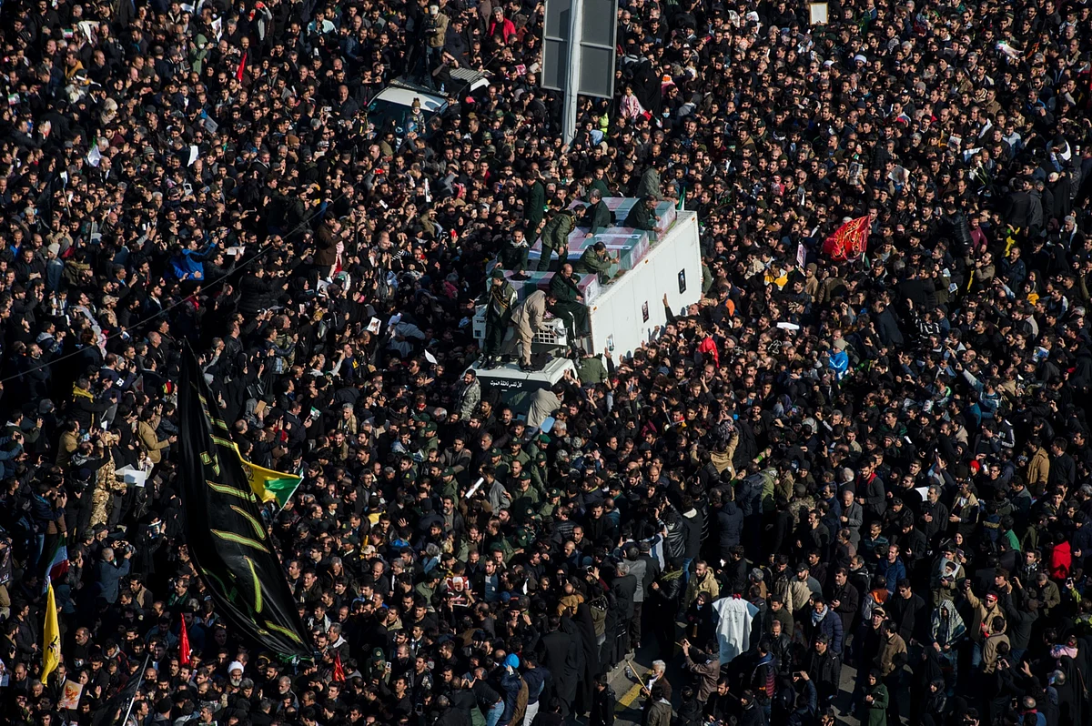 Mourners surround the coffins of Iranian General Qassem Soleimani and others killed in the U.S. airstrike during a funeral ceremony in Tehran, Iran. (Photographer: Ali Mohammadi/Bloomberg)