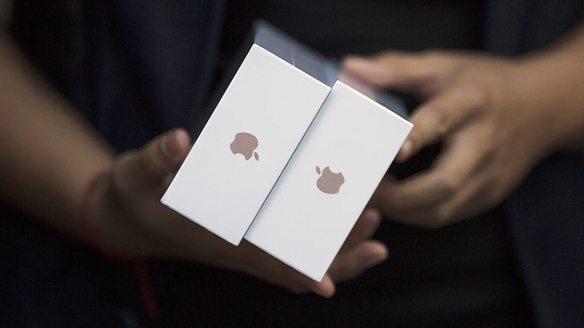 One of the first customers holds his phones as Apple iPhone 6s and 6s Plus go on sale at an Apple Store in Beijing. 