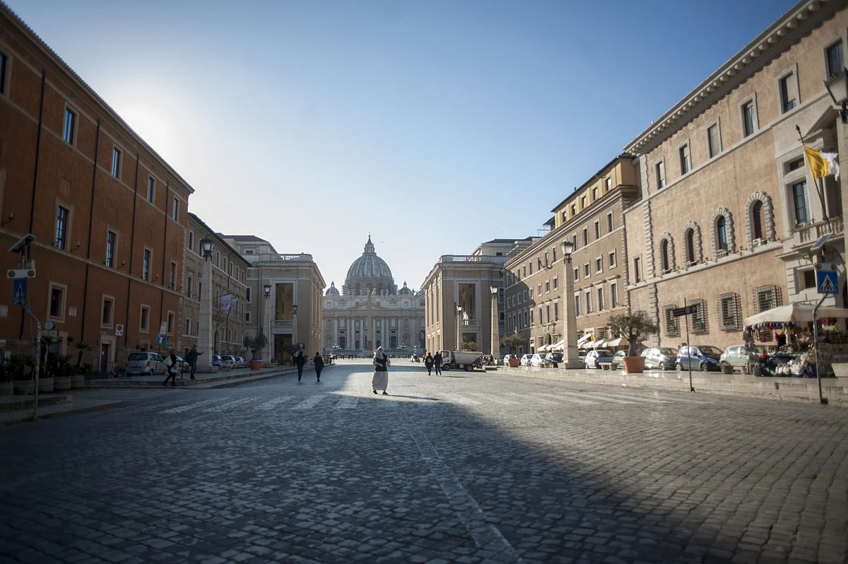 A pedestrian crosses the street, in view of in Saint Peter’s Basilica in Vatican State, on Wednesday, March 11, 2020. (Photographer: Geraldine Hope Ghelli/Bloomberg)