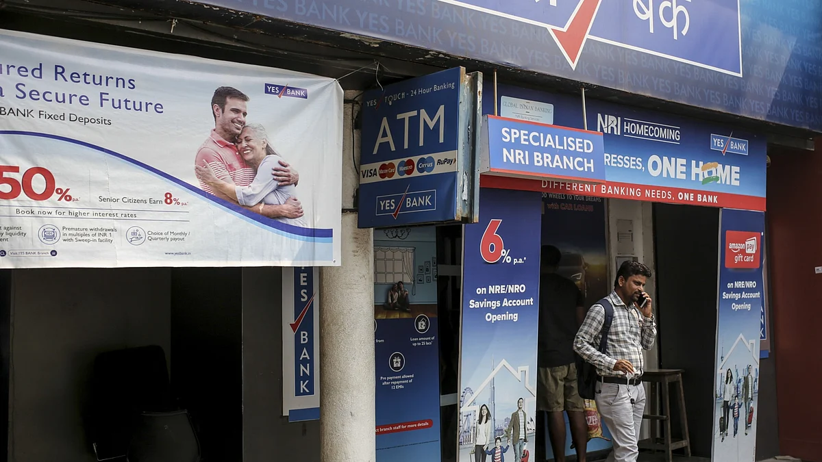 A customer exists a Yes Bank bank branch in Mumbai, India. (Photographer: Dhiraj Singh/Bloomberg)