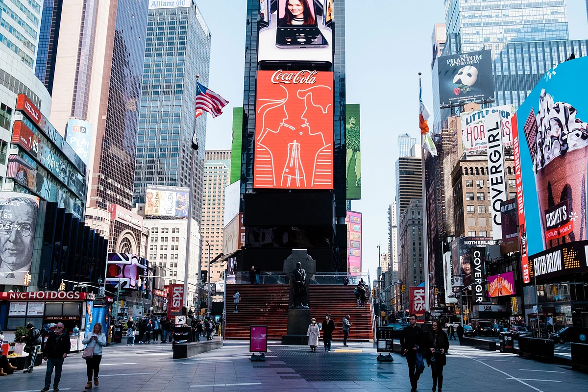 Pedestrians walk along a street in the Times Square neighborhood of New York, U.S., on Monday, March 16, 2020. (Photographer: Gabriela Bhaskar/Bloomberg)