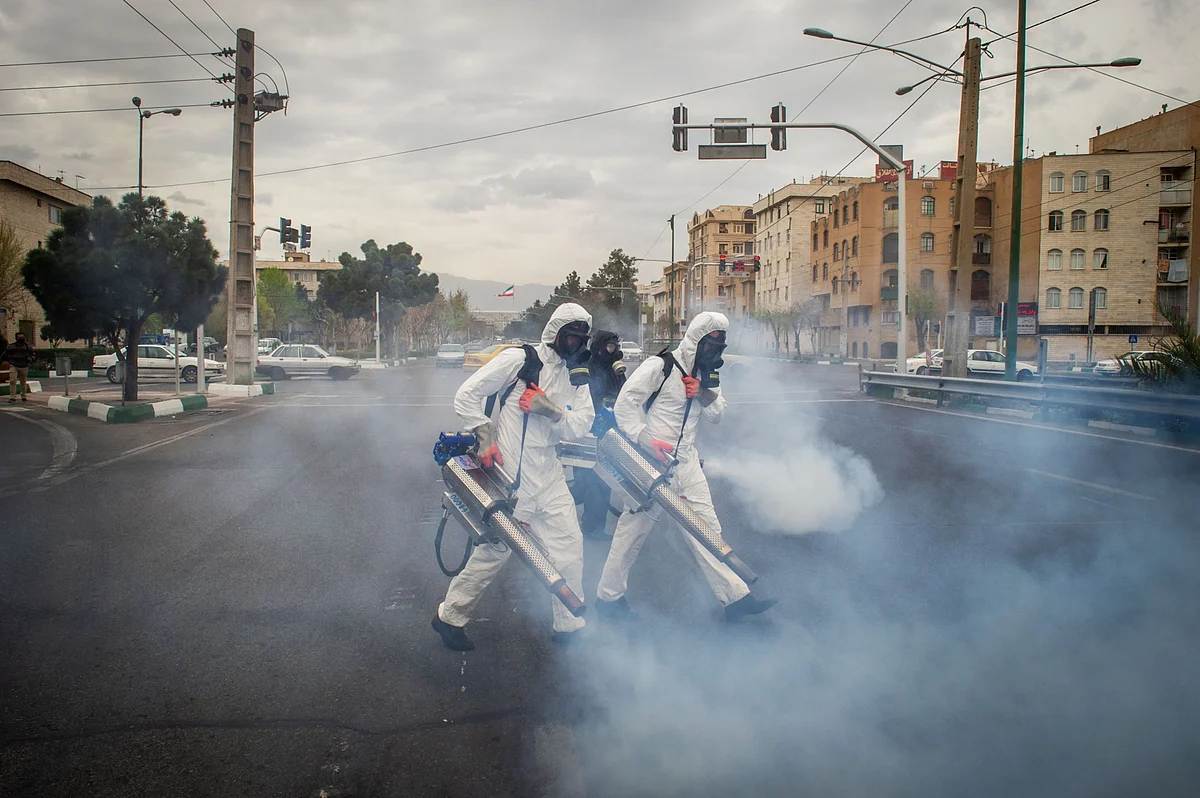Firefighters use fog machines to disinfect public streets following the outbreak of coronavirus in Tehran, Iran, on Wednesday, March 18, 2020. Iran’s health sector is already struggling to cope with the coronavirus epidemic, with 17,000 infected and more than 1,100 having died. (Photographer: Ali Mohammadi/Bloomberg)