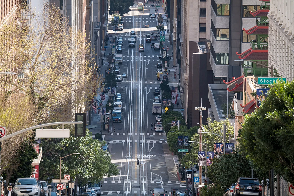 A pedestrian crosses an empty California Street during rush hour in San Francisco, California, U.S., on Tuesday, March 17, 2020. Six of the biggest counties in the San Francisco Bay Area ordered people to stay home except for essential needs, marking one of the nation’s strongest local efforts yet to stem the spread of the coronavirus. (Photographer: David Paul Morris/Bloomberg)