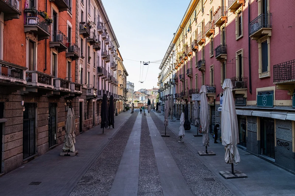 Umbrellas outside closed cafes line a street leading to the Navigli canal system on April 8. (Photographer: Francesca Volpi/Bloomberg) 