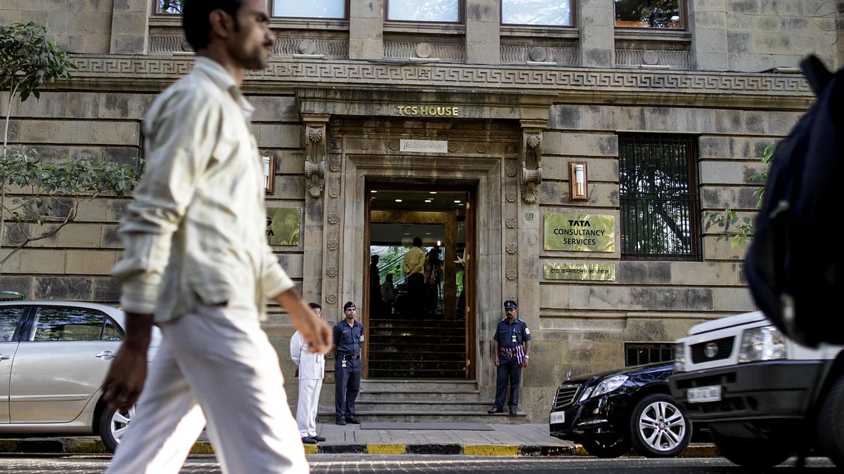 A man walks past the Tata Consultancy Services Ltd. headquarters in Mumbai, India. (Photographer: Dhiraj Singh/Bloomberg)
