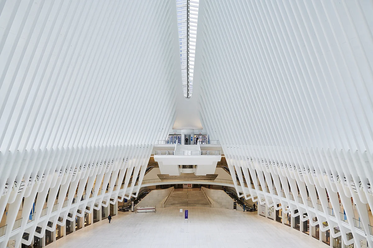 A lone pedestrian walks inside the Oculus, a transportation and shopping hub in Manhattan’s financial district on March 30. (Photographer: Gabby Jones/Bloomberg) 