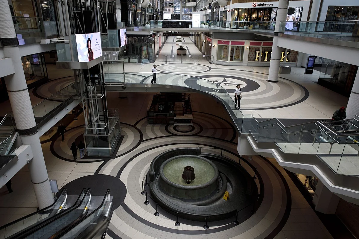 Security guards are among the few people inside the Toronto Eaton Centre on March 25. (Photographer: Cole Burston/Bloomberg) 