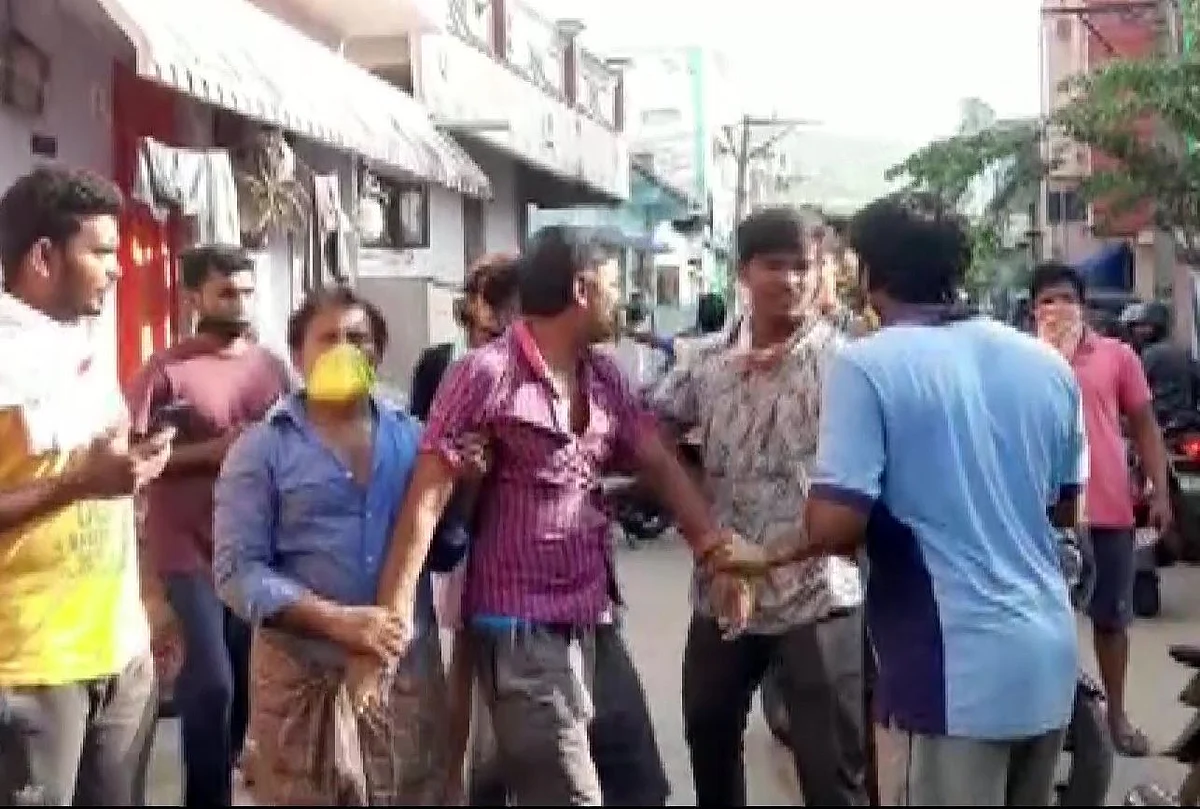 People comfort a man during an evacuation operation in Vizag. (Photo: ANI/Twitter)