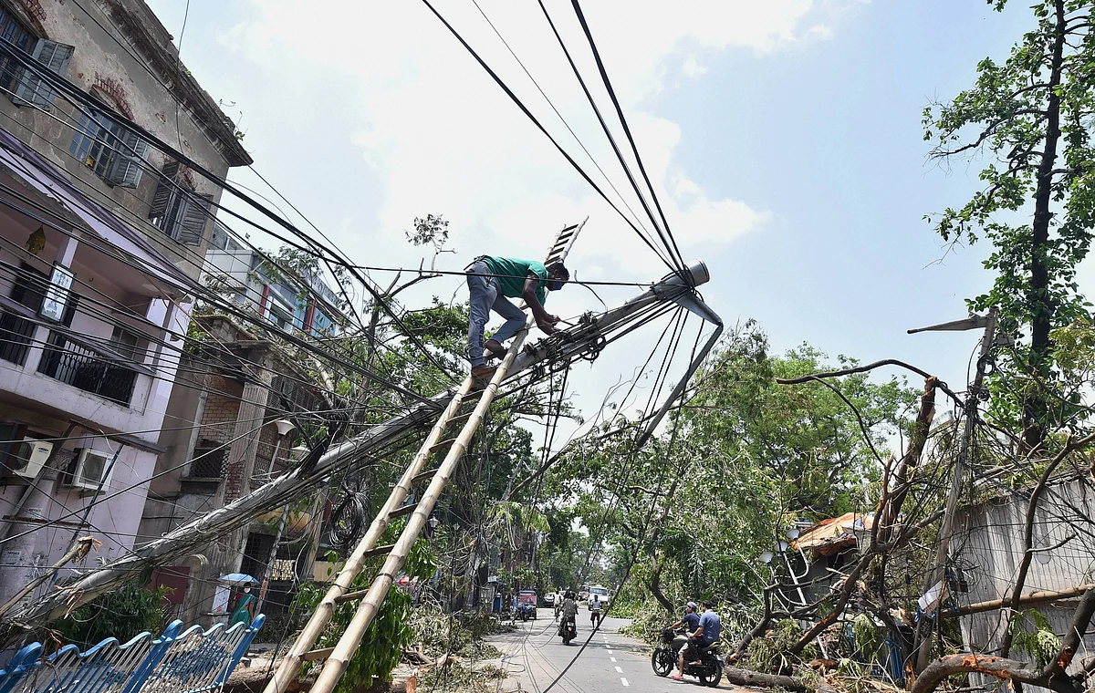 An electricity technician works on an electricity pole in Kolkata after the destruction from cyclone Amphan. (Source: PTI)