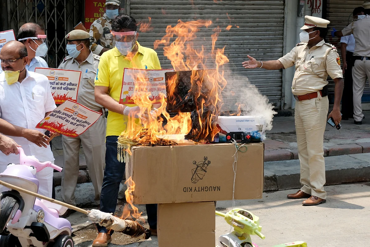 Protesters burn an image of Chinese President Xi Jinping at a demonstration. (Photographer. T. Narayan/Bloomberg)