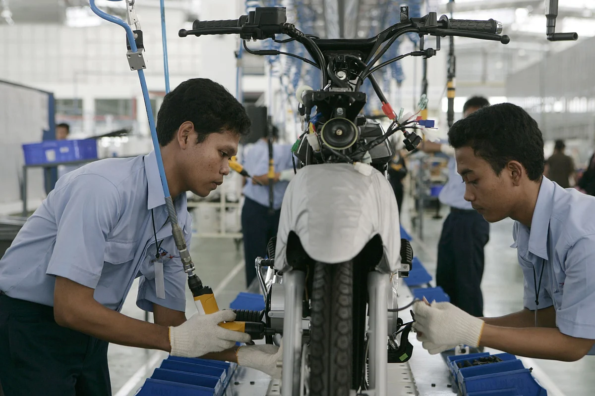 TVS Motor employees work on the vehicle production line at company’s factory in Karawang, Indonesia. (Photographer: Dimas Ardian/Bloomberg)