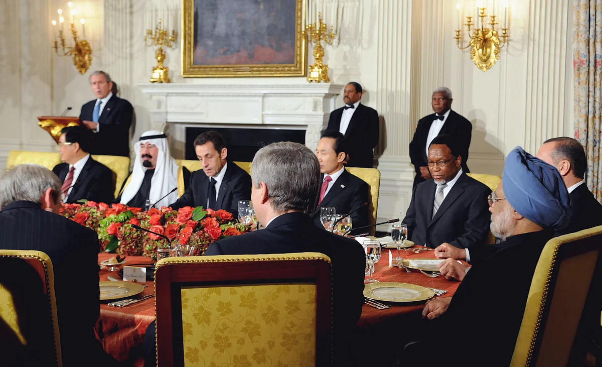 Prime Minister Manmohan Singh and other G20 leaders listen to U.S. President George Bush in an meeting called to address the global financial crisis, at the White House in Washington D.C., on Nov. 14, 2008. (Photograph: PIB)