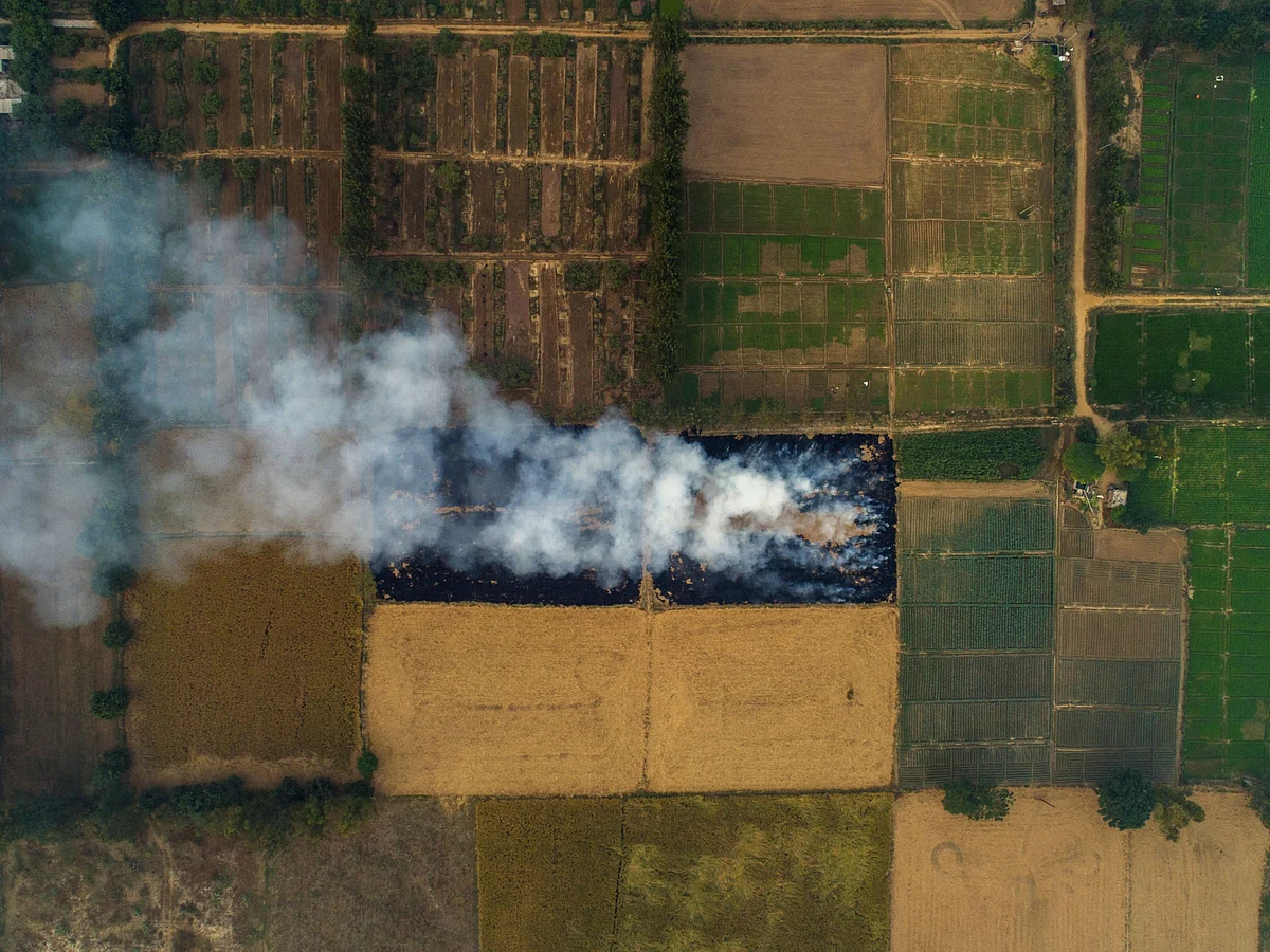Smoke rises from the burning of rice crop stubble in this aerial photograph taken over Patiala district of Punjab, India. (Photographer: Prashanth Vishwanathan/Bloomberg)