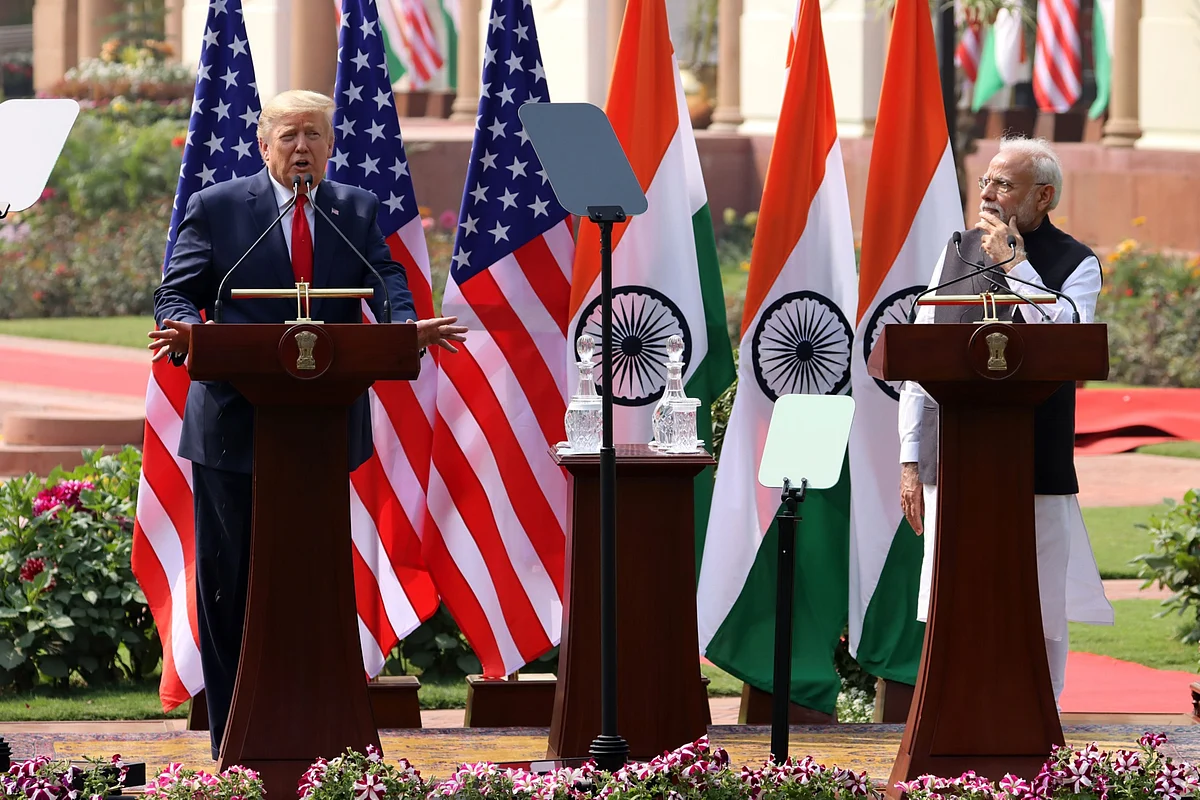 U.S. President Donald Trump speaks as Indian Prime Minister Narendra Modi, listens, in New Delhi, on Feb. 25, 2020. (Photographer: T. Narayan/Bloomberg)