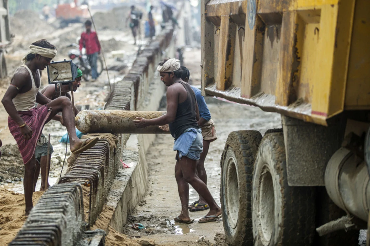 Labourers work on the construction site for an overpass in Patna. (Photographer: Prashanth Vishwanathan/Bloomberg)