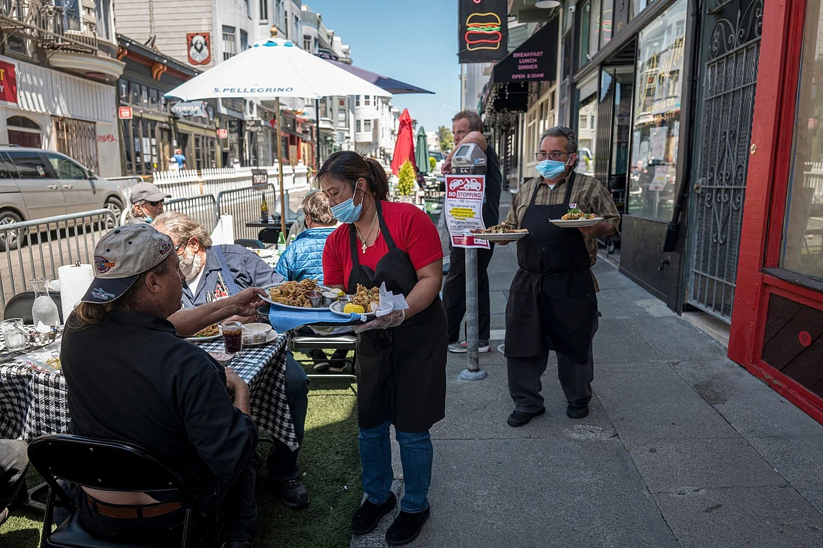 California Closes Indoor Restaurants And Bars Statewide As Coronavirus Cases RiseServers wearing protective masks serve food to customers dining outside on Grant Street in San Francisco, California, U.S., on Tuesday, July 14, 2020. (Photographer: David Paul Morris/Bloomberg)