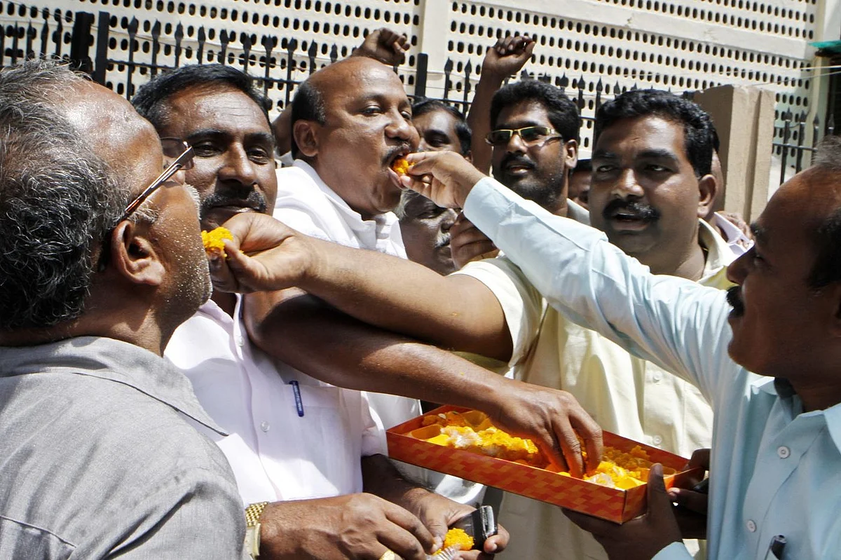 Supporters of A. Raja distribute sweets after court granted him bail in 2G Spectrum case, 2012. (Photo: Sonu Mehta/Hindustan Times via Getty Image)