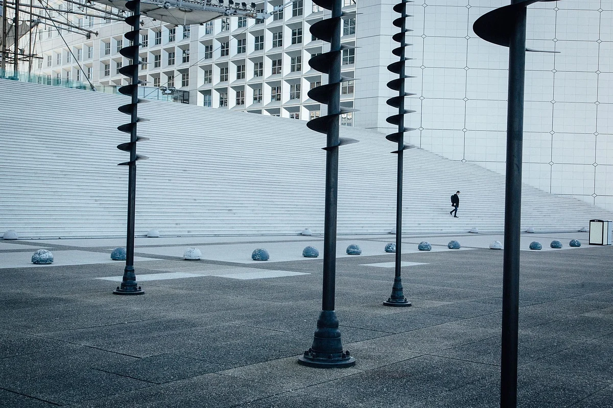 A pedestrian at La Defense’s Grande Arche in Paris on March 24. Photographer: Cyril Marcilhacy/Bloomberg 