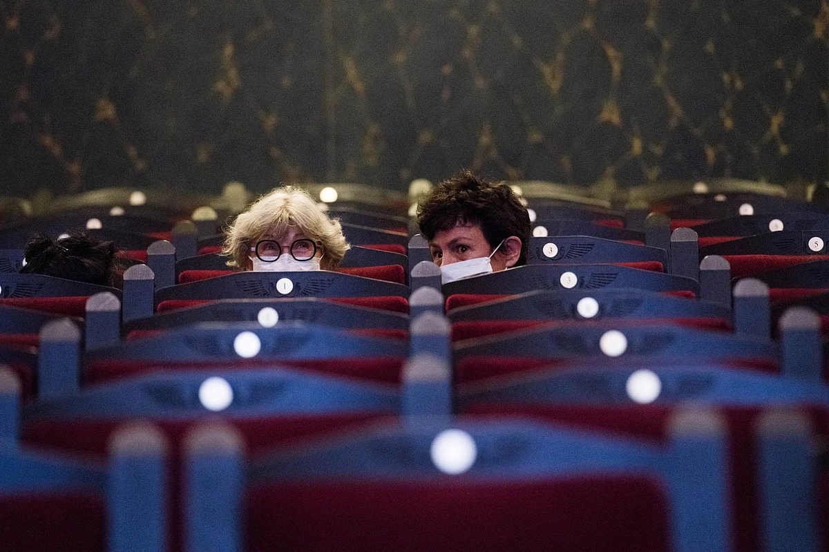Two women at the Louxor cinema in Paris on June 22, the day it reopened. Photographer: Nathan Laine/Bloomberg 