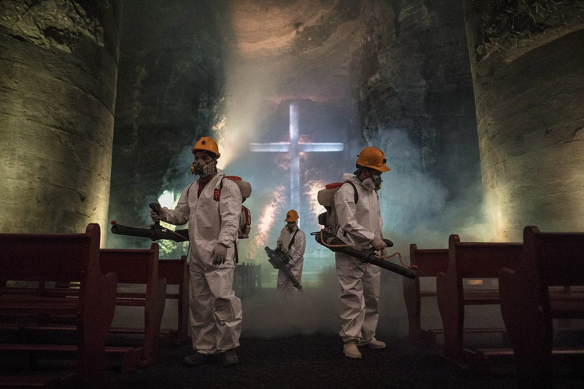 Workers disinfect the central nave of the Salt Cathedral in Zipaquira, Colombia, on April 8, during a nationwide lockdown. Photographer: Ivan Valencia/Bloomberg