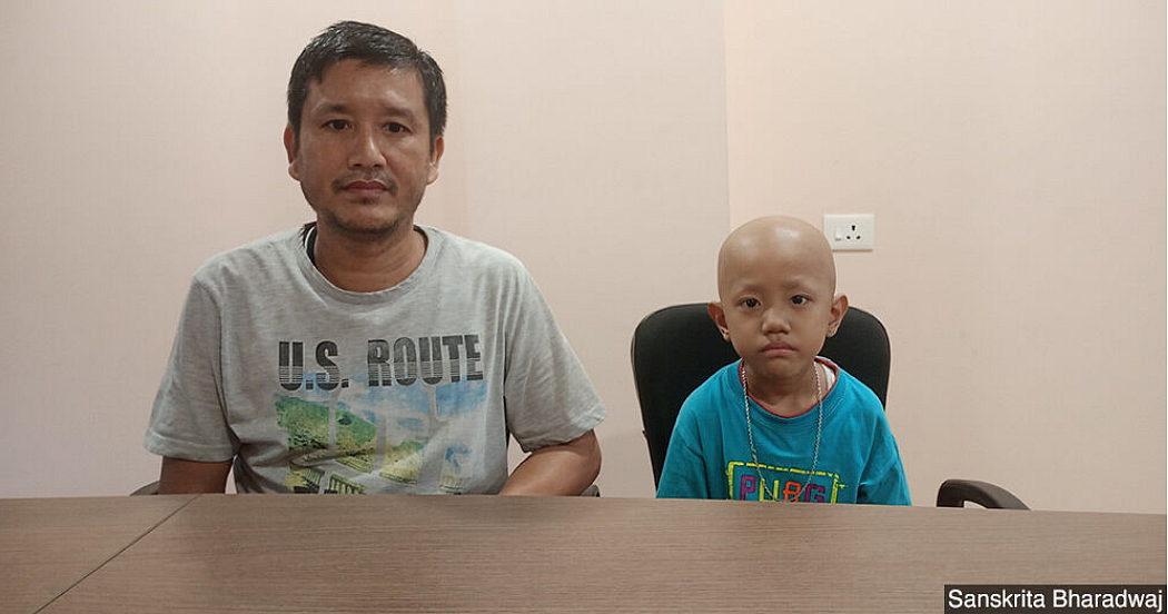 Lalchemla Singh with his son Kiran Singh. Kiran was diagnosed with small cell tumour. They travelled from Manipur to Assam for treatment.